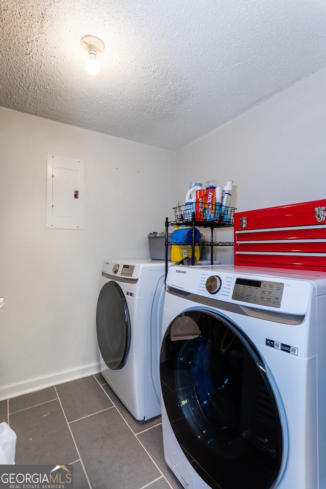 72 Sutton Pl, Avondale Estates, GA 30002 - washroom with electric panel, washing machine and clothes dryer, tile patterned flooring, a textured ceiling, and baseboards