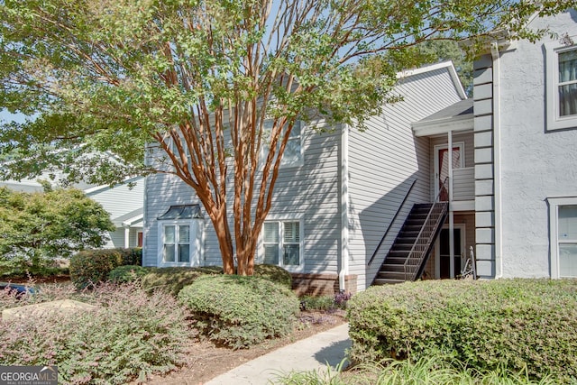 72 Sutton Pl, Avondale Estates, GA 30002 - view of home's exterior featuring stucco siding and stairway