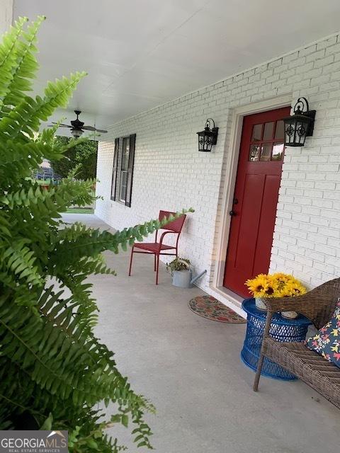 3827 Avant Rd, Blackshear, GA 31516 - property entrance featuring brick siding, covered porch, and a ceiling fan