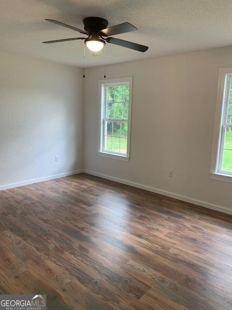 3827 Avant Rd, Blackshear, GA 31516 - spare room featuring dark wood-style floors, baseboards, ceiling fan, and a textured ceiling