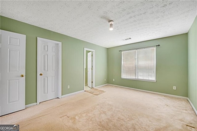 424 Yellow River Walk, Lawrenceville, GA 30043 - unfurnished bedroom with carpet, baseboards, and a textured ceiling