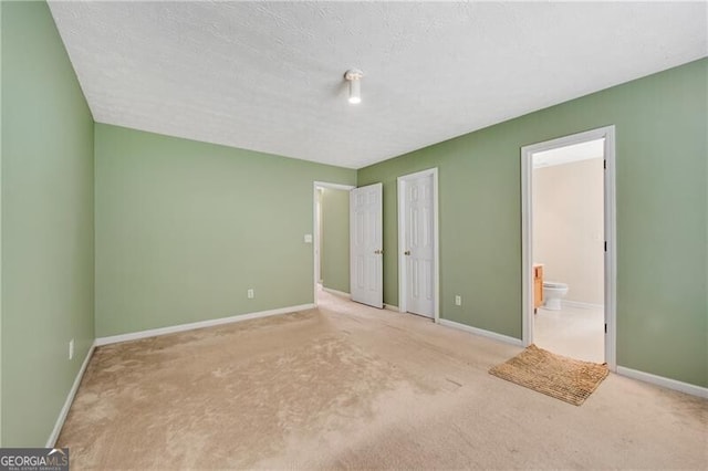 424 Yellow River Walk, Lawrenceville, GA 30043 - unfurnished bedroom with carpet flooring, ensuite bath, and baseboards