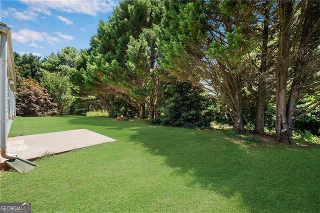 424 Yellow River Walk, Lawrenceville, GA 30043 - view of green lawn with a patio
