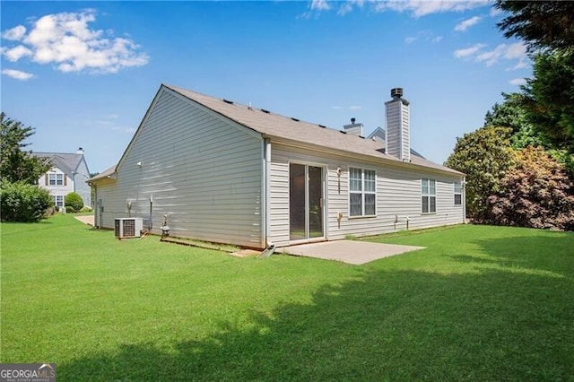 424 Yellow River Walk, Lawrenceville, GA 30043 - back of house featuring a lawn, a chimney, a patio area, and cooling unit
