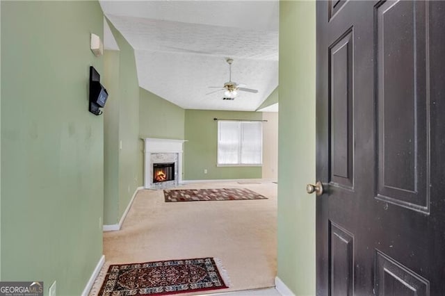 424 Yellow River Walk, Lawrenceville, GA 30043 - entrance foyer featuring baseboards, a ceiling fan, vaulted ceiling, a high end fireplace, and carpet floors