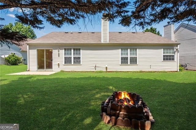 424 Yellow River Walk, Lawrenceville, GA 30043 - back of house featuring a fire pit, a lawn, a chimney, and central AC