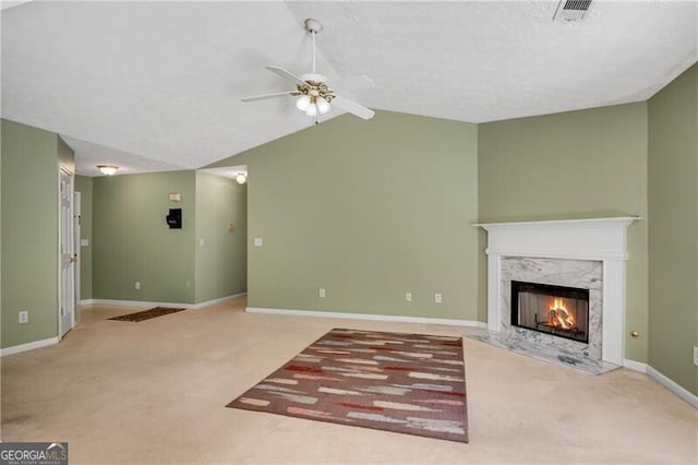 424 Yellow River Walk, Lawrenceville, GA 30043 - unfurnished living room featuring carpet, ceiling fan, a high end fireplace, lofted ceiling, and baseboards