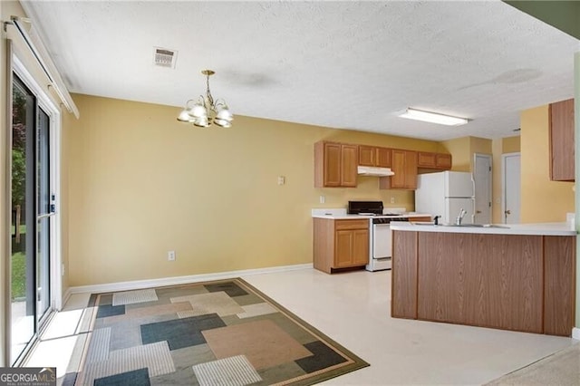 424 Yellow River Walk, Lawrenceville, GA 30043 - kitchen with white appliances, under cabinet range hood, a chandelier, light countertops, and a peninsula