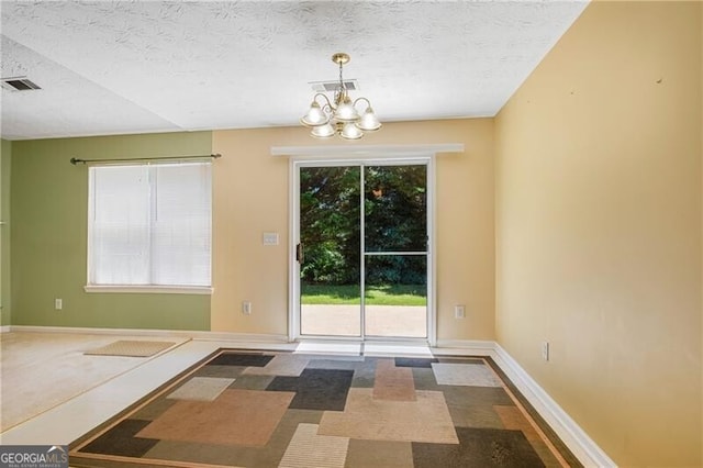 424 Yellow River Walk, Lawrenceville, GA 30043 - unfurnished dining area with a textured ceiling, a chandelier, and baseboards