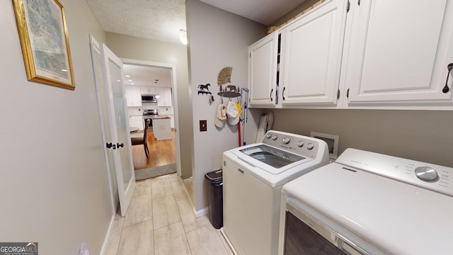 2884 Overwood Ln, Snellville, GA 30078 - laundry room with cabinet space, separate washer and dryer, and light tile patterned flooring