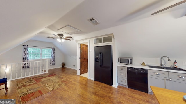 2884 Overwood Ln, Snellville, GA 30078 - kitchen with black appliances, light wood-style floors, light countertops, vaulted ceiling, and ceiling fan