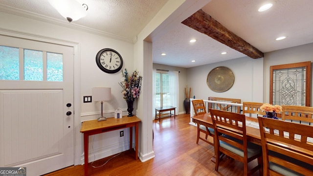 2884 Overwood Ln, Snellville, GA 30078 - dining area featuring light wood-style floors, recessed lighting, a textured ceiling, beamed ceiling, and ornamental molding