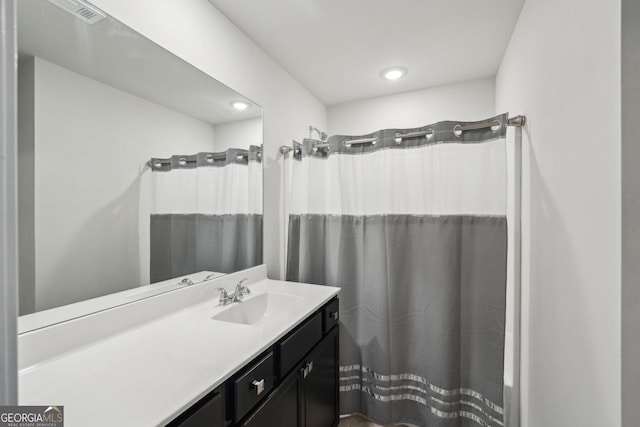 6024 Park Bay Ct, Flowery Branch, GA 30542 - bathroom featuring vanity, curtained shower, and recessed lighting