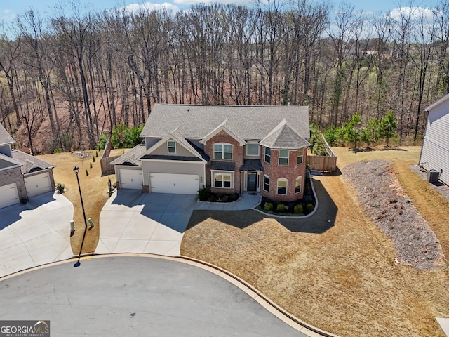 6024 Park Bay Ct, Flowery Branch, GA 30542 - view of front of home featuring driveway, a shingled roof, a garage, and brick siding