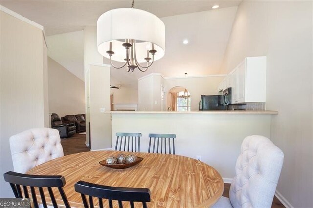 2577 Abbotts Glen Dr NW, Acworth, GA 30101 - dining room with a chandelier and lofted ceiling