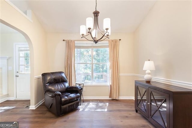 2577 Abbotts Glen Dr NW, Acworth, GA 30101 - living area featuring arched walkways, a chandelier, wood finished floors, and lofted ceiling