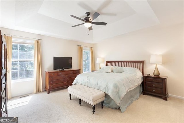 2577 Abbotts Glen Dr NW, Acworth, GA 30101 - bedroom with a raised ceiling, light colored carpet, and a ceiling fan