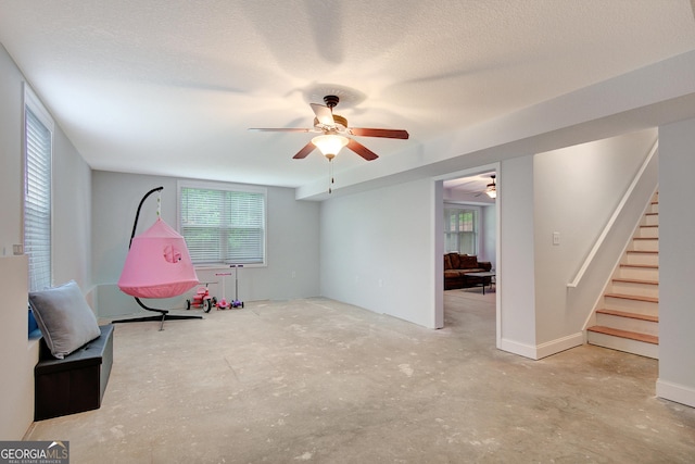 108 Hidden Springs Dr, Lagrange, GA 30240 - unfurnished room featuring ceiling fan, unfinished concrete flooring, stairway, and a textured ceiling