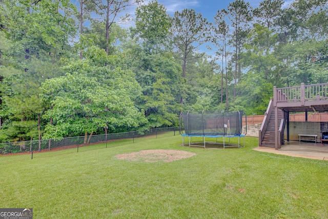 108 Hidden Springs Dr, Lagrange, GA 30240 - fenced backyard featuring stairs, a trampoline, a patio area, and a wooden deck