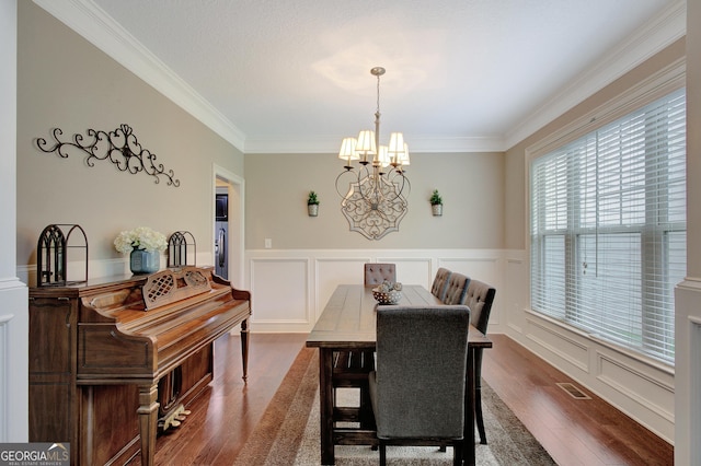 108 Hidden Springs Dr, Lagrange, GA 30240 - dining area with a chandelier, dark wood finished floors, ornamental molding, wainscoting, and a decorative wall