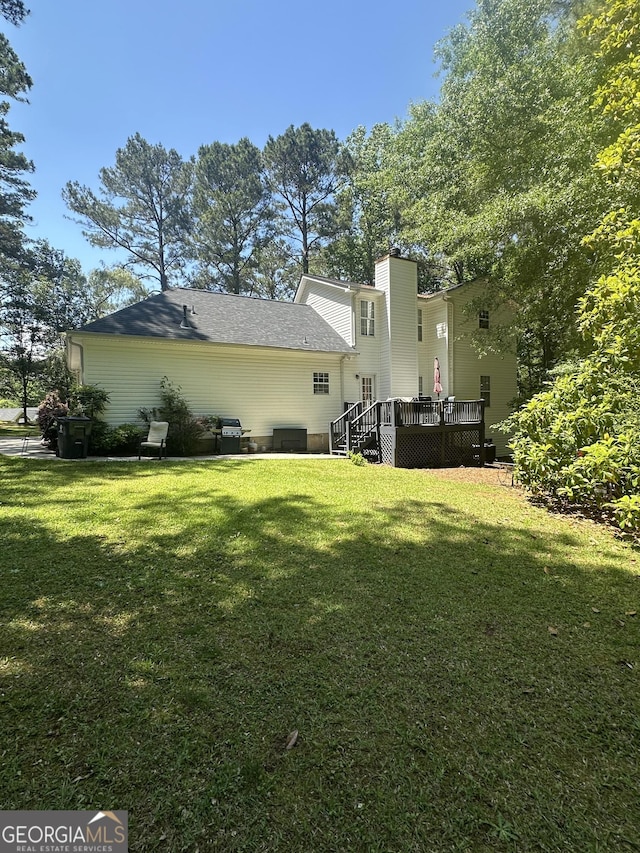 65 Barclay Ct, Newnan, GA 30263 - back of house featuring a wooden deck and a yard