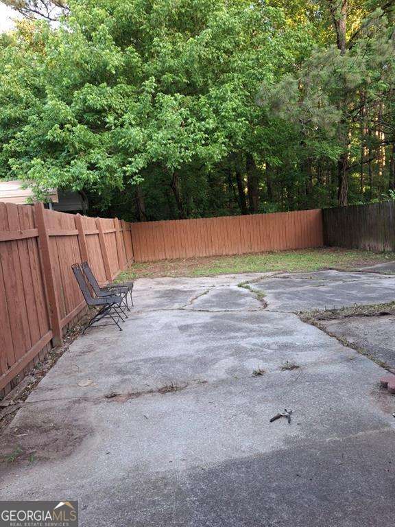 3530 Hopkins Ct, Powder Springs, GA 30127 - fenced backyard with a patio