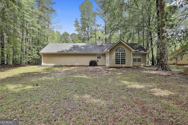 24 Four Oaks Dr, Newnan, GA 30263 - back of house featuring a chimney and a yard