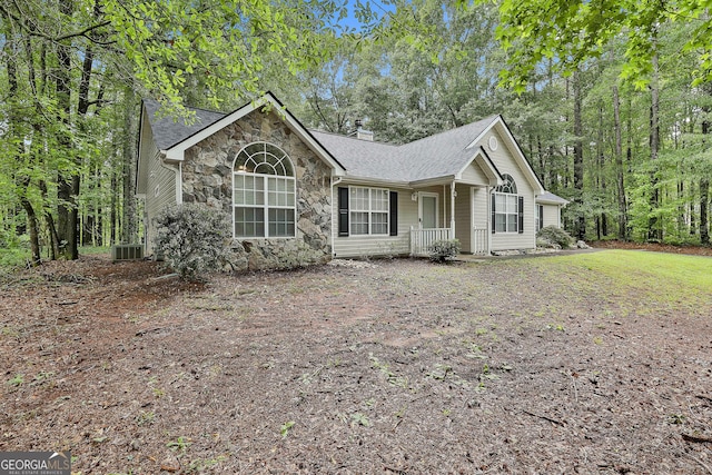 24 Four Oaks Dr, Newnan, GA 30263 - ranch-style home with stone siding, a porch, a chimney, and central AC