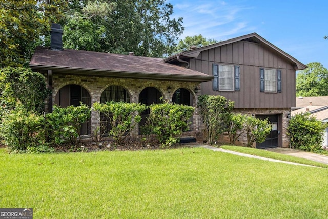 2209 Willoby Ct, Morrow, GA 30260 - tri-level home with an attached garage, a front yard, a chimney, and board and batten siding