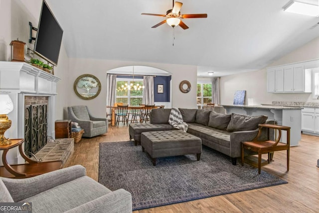 632 Holly Springs Ct, Athens, GA 30606 - living area with ceiling fan, a chandelier, light wood-style flooring, high vaulted ceiling, and arched walkways
