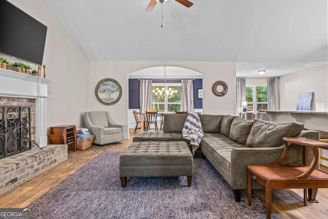 632 Holly Springs Ct, Athens, GA 30606 - living area featuring ceiling fan, wood finished floors, a brick fireplace, vaulted ceiling, and a chandelier