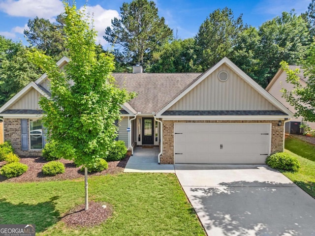 632 Holly Springs Ct, Athens, GA 30606 - view of front facade with brick siding, a garage, board and batten siding, and driveway