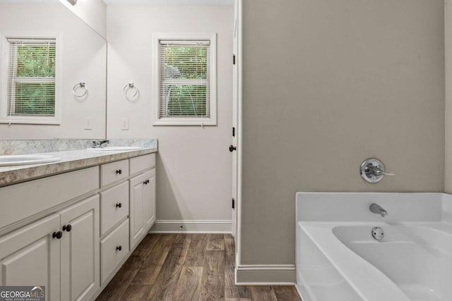 632 Holly Springs Ct, Athens, GA 30606 - full bath with double vanity, healthy amount of natural light, a bath, and wood finished floors