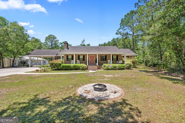 1206 Zittrouer Rd, Guyton, GA 31312 - ranch-style house featuring covered porch, driveway, a chimney, a front yard, and an attached carport