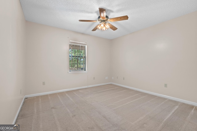 1206 Zittrouer Rd, Guyton, GA 31312 - spare room featuring ceiling fan, carpet, a textured ceiling, and baseboards