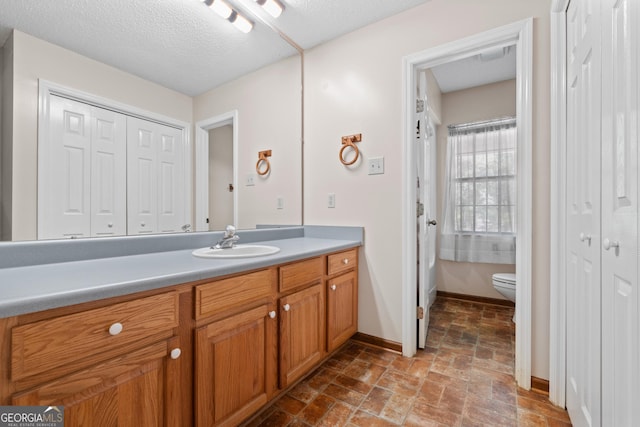 1206 Zittrouer Rd, Guyton, GA 31312 - full bathroom featuring vanity, a closet, toilet, and stone finish flooring