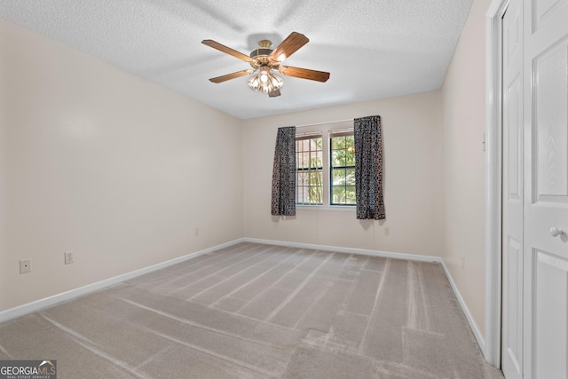 1206 Zittrouer Rd, Guyton, GA 31312 - spare room featuring a ceiling fan, light carpet, a textured ceiling, and baseboards