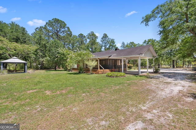 1206 Zittrouer Rd, Guyton, GA 31312 - view of green lawn with a gazebo, a carport, and a sunroom