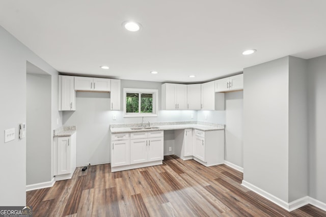 399 N Chestatee St, Dahlonega, GA 30533 - kitchen with a sink, light stone countertops, wood finished floors, white cabinetry, and recessed lighting