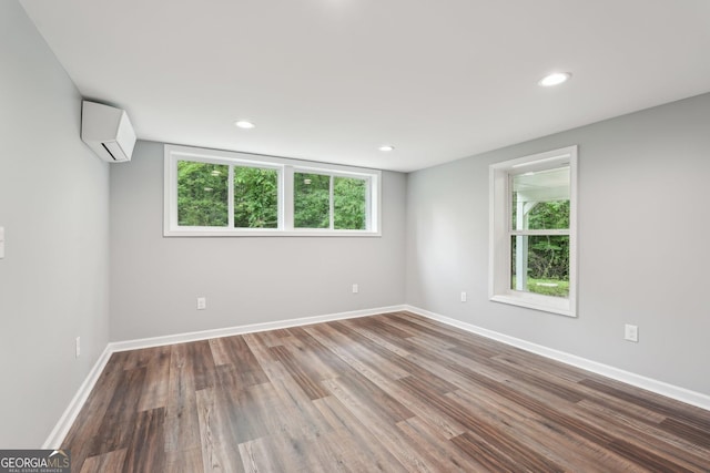 399 N Chestatee St, Dahlonega, GA 30533 - unfurnished room with an AC wall unit, healthy amount of natural light, wood finished floors, baseboards, and recessed lighting