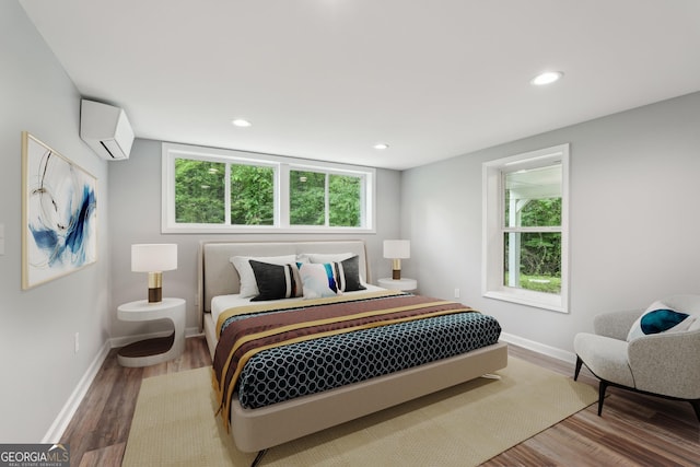 399 N Chestatee St, Dahlonega, GA 30533 - bedroom featuring a wall unit AC, wood finished floors, baseboards, multiple windows, and recessed lighting