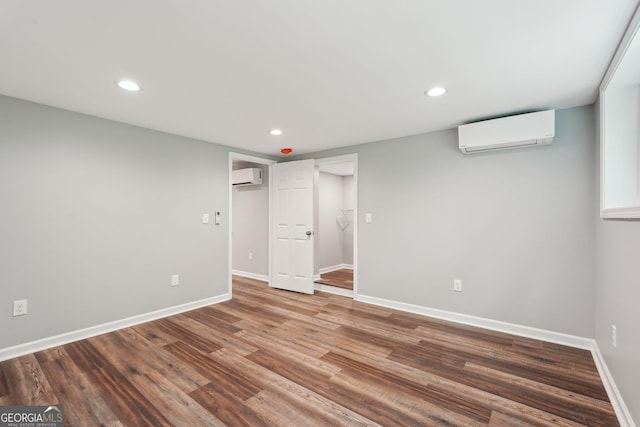 399 N Chestatee St, Dahlonega, GA 30533 - unfurnished bedroom featuring a wall mounted AC, baseboards, recessed lighting, and wood finished floors