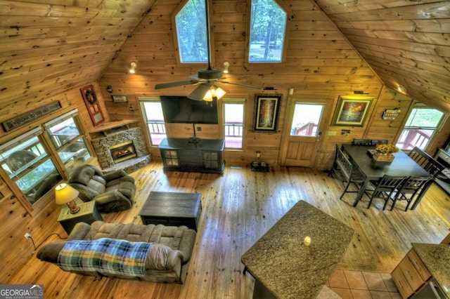 241 Dunn Mill Creek Rd, Blue Ridge, GA 30513 - living room featuring wood walls, high vaulted ceiling, wood-type flooring, wooden ceiling, and a ceiling fan
