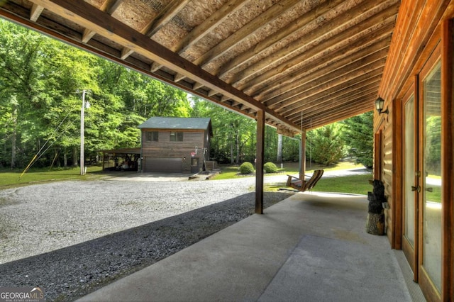 241 Dunn Mill Creek Rd, Blue Ridge, GA 30513 - view of patio featuring an outdoor structure, a garage, and gravel driveway