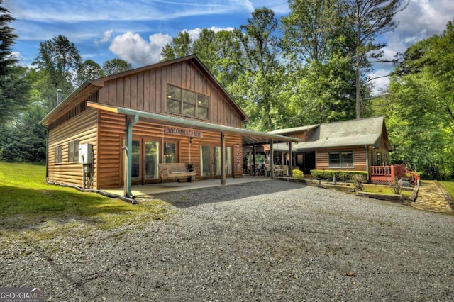 241 Dunn Mill Creek Rd, Blue Ridge, GA 30513 - rustic home with board and batten siding, faux log siding, and french doors