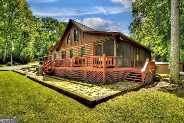 241 Dunn Mill Creek Rd, Blue Ridge, GA 30513 - rear view of house featuring a sunroom, board and batten siding, a deck, and a yard