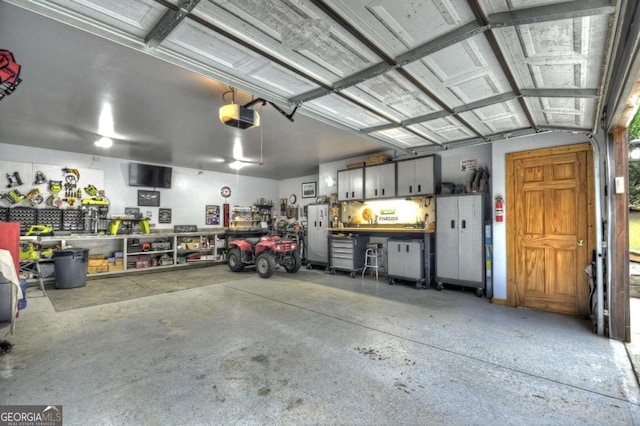 241 Dunn Mill Creek Rd, Blue Ridge, GA 30513 - garage with a workshop area and a garage door opener