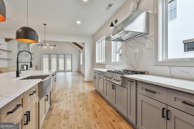 1240 Hayes Sq, Peachtree City, GA 30269 - kitchen with ventilation hood, stainless steel gas stovetop, gray cabinetry, light stone countertops, and recessed lighting