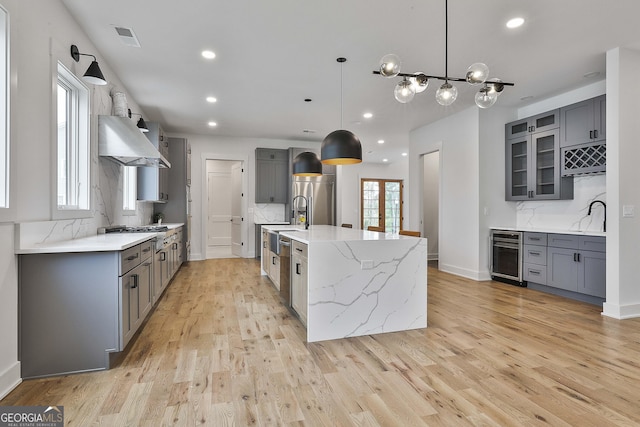 1240 Hayes Sq, Peachtree City, GA 30269 - kitchen with gray cabinets, wine cooler, stainless steel fridge, range hood, and recessed lighting