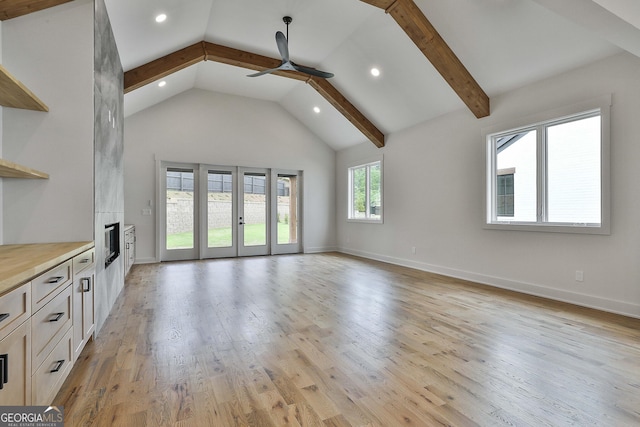 1240 Hayes Sq, Peachtree City, GA 30269 - unfurnished living room with a ceiling fan, recessed lighting, beamed ceiling, french doors, and light wood-style flooring